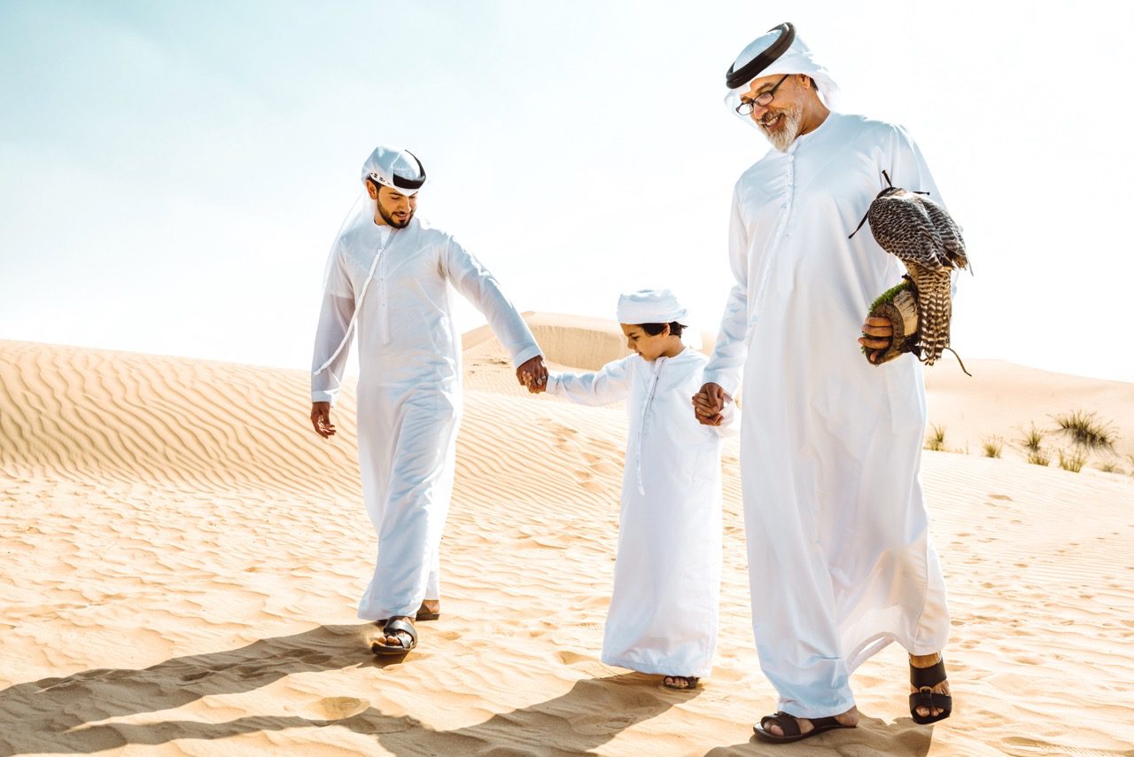 A family walking in a Dune in Arabian Ranches, Dubai. Family-friendly communities in Dubai