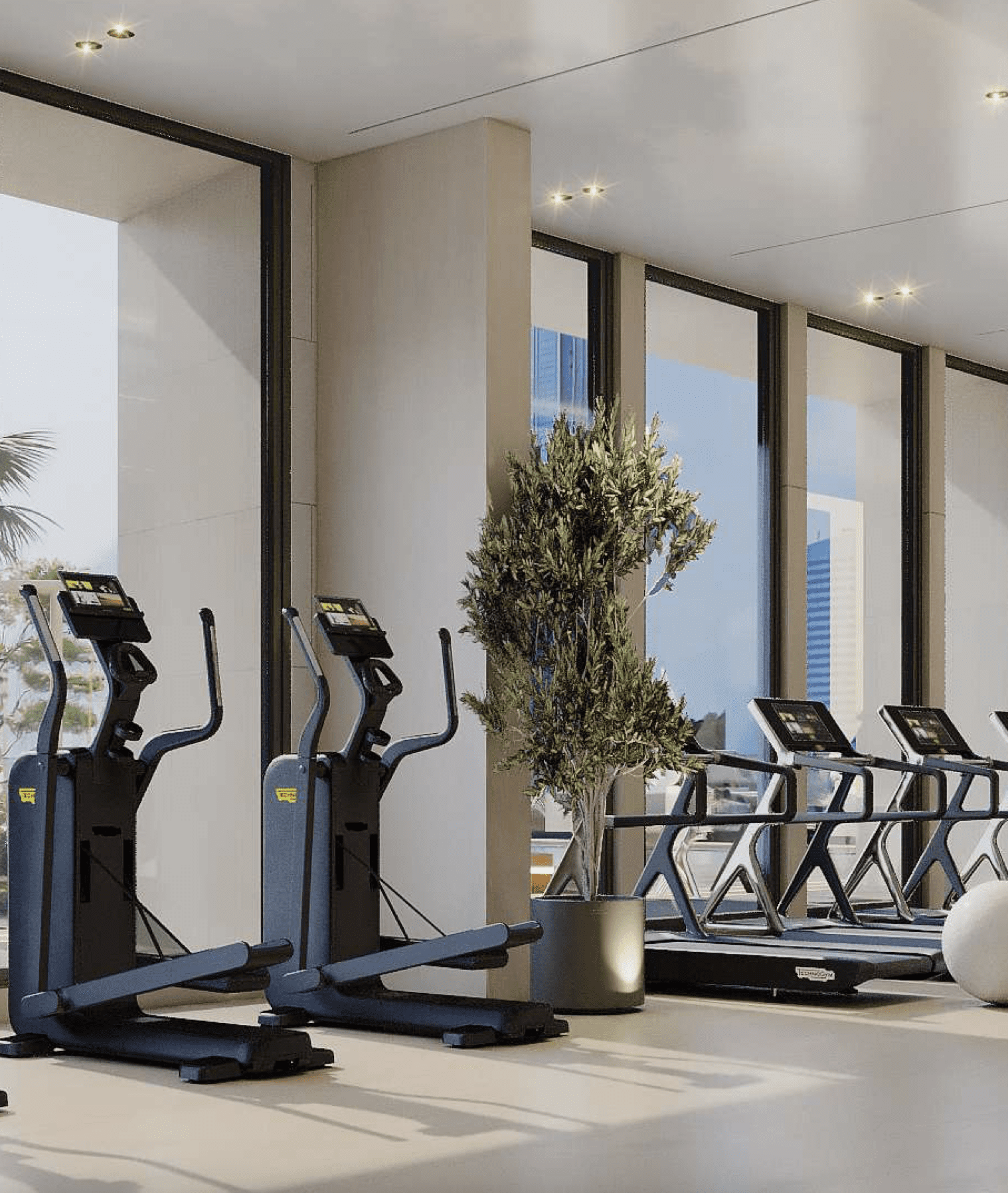 Modern gym with advanced fitness equipment and city views at Cubix Residences, Jumeirah Village Circle, Dubai.