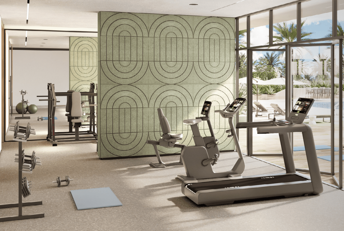 State-of-the-art gym at Roma Residences, equipped with modern fitness equipment, large windows with a pool view, and a serene ambiance.