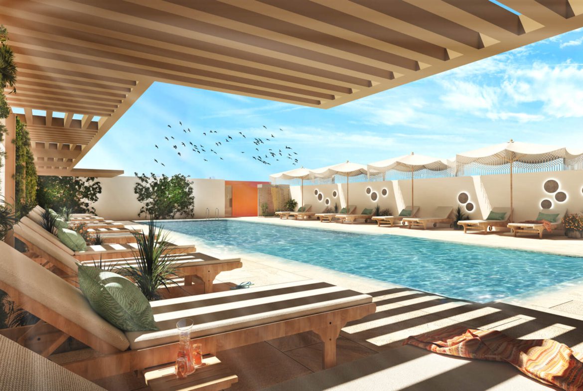 Refreshing swimming pool area in Luma22, surrounded by lounge chairs and shaded cabanas for relaxation.