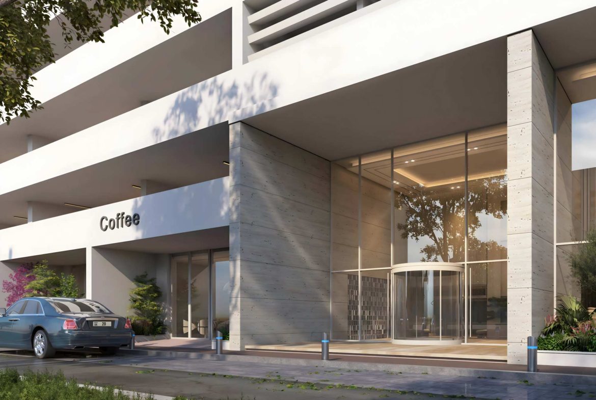 Front entrance of Luma Park Views featuring a sleek modern design and a coffee shop, creating a welcoming atmosphere for residents and visitors.