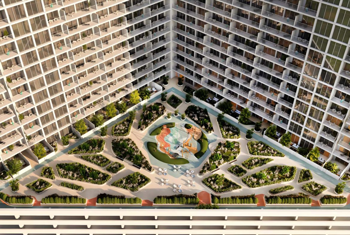 Aerial view of the lush green courtyard at Luma Park Views, featuring landscaped gardens and outdoor seating areas for residents