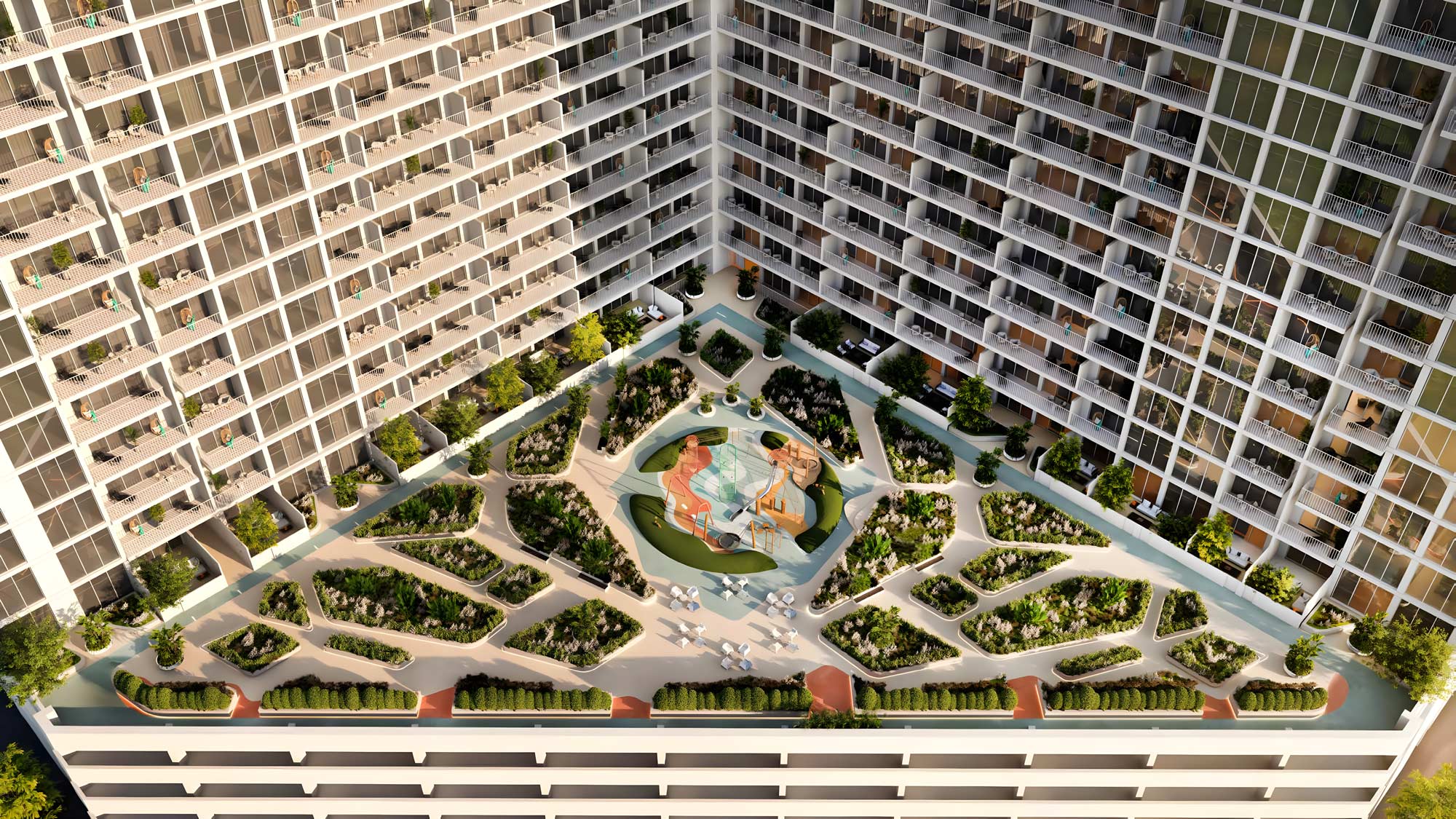 Aerial view of the lush green courtyard at Luma Park Views, featuring landscaped gardens and outdoor seating areas for residents