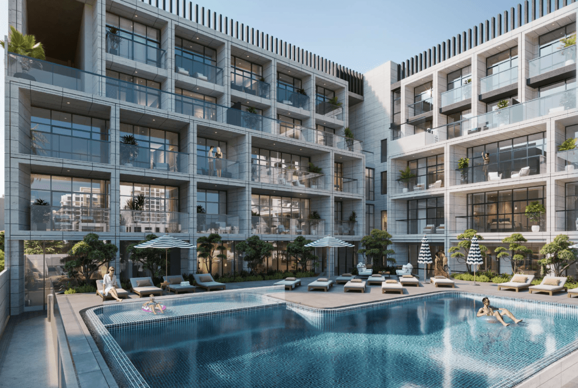 Elegant outdoor swimming pool with lounge chairs and modern building facade at Cubix Residences, Jumeirah Village Circle.