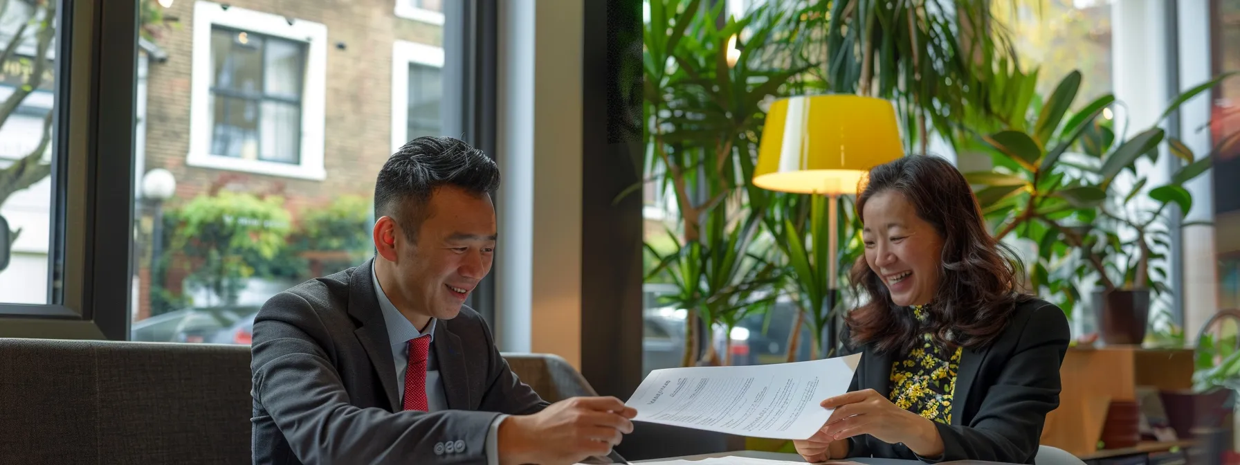 a tenant confidently reviewing legal documents with a knowledgeable estate agent in a modern office setting.