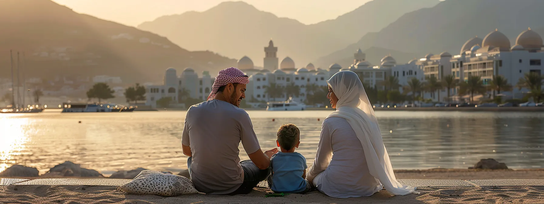 a family sitting together with a view of serene khor fakkan in the background, discussing their healthcare and insurance options as they prepare for their move to the uae.