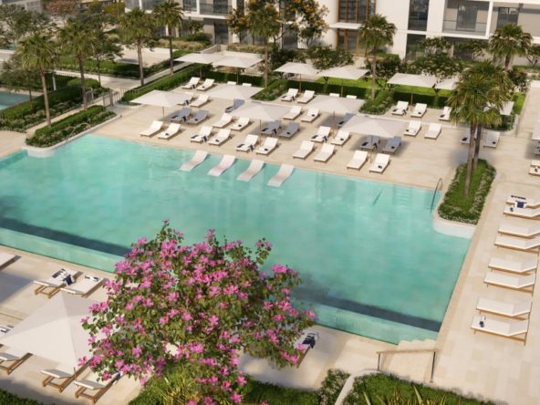 Poolside area at Cello by Taraf featuring lounge chairs and a landscaped garden.